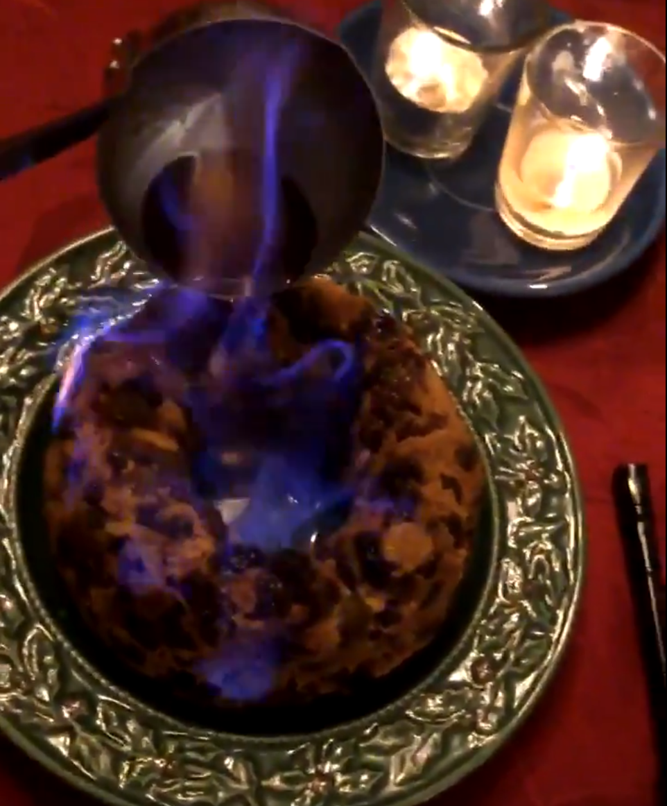 Igniting the Plum Pudding Ignited brandy is poured over plum pudding