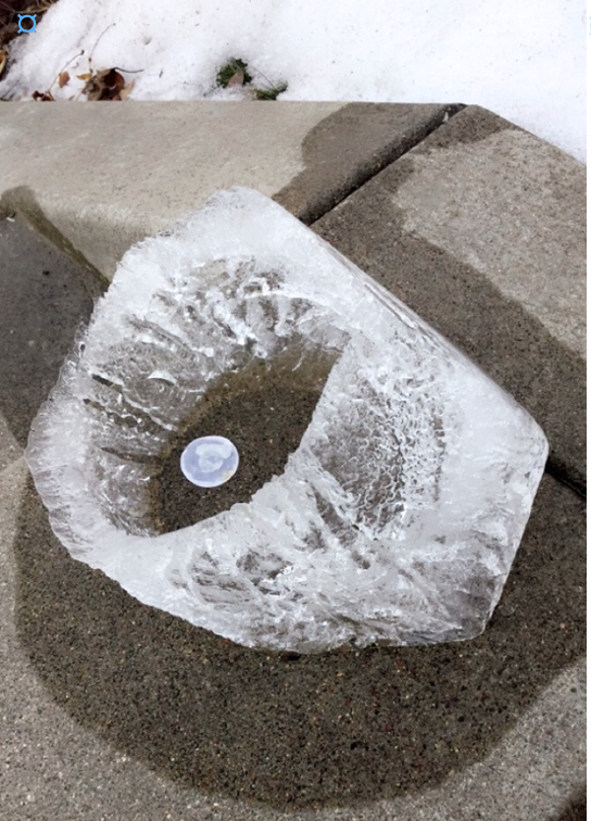 Thaw: a half-melted ice lantern on a concrete stair